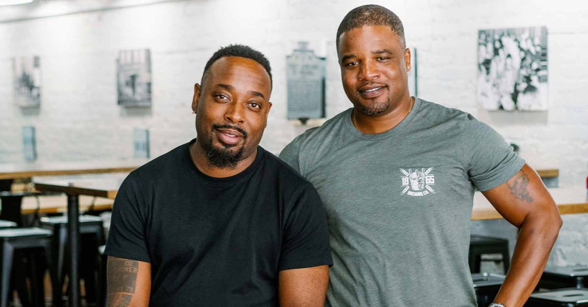 brewery owners posing together inside taproom