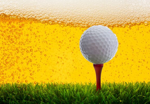 golf ball on greens with craft beer background