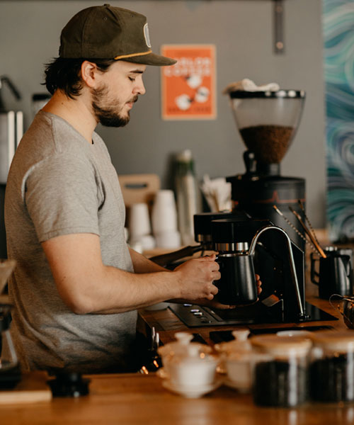 man preparing coffee in brewery