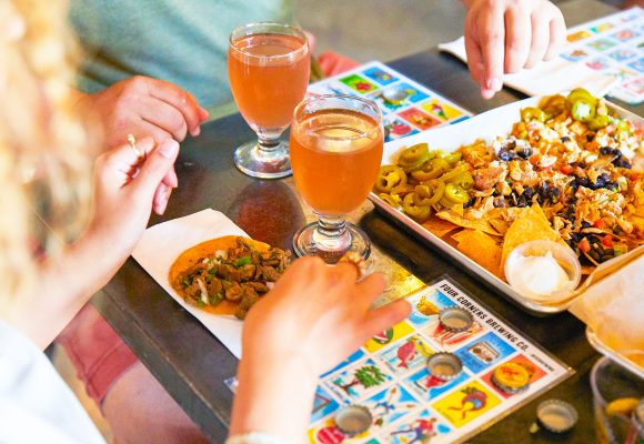 people playing bingo and drinking beer and eating nachos