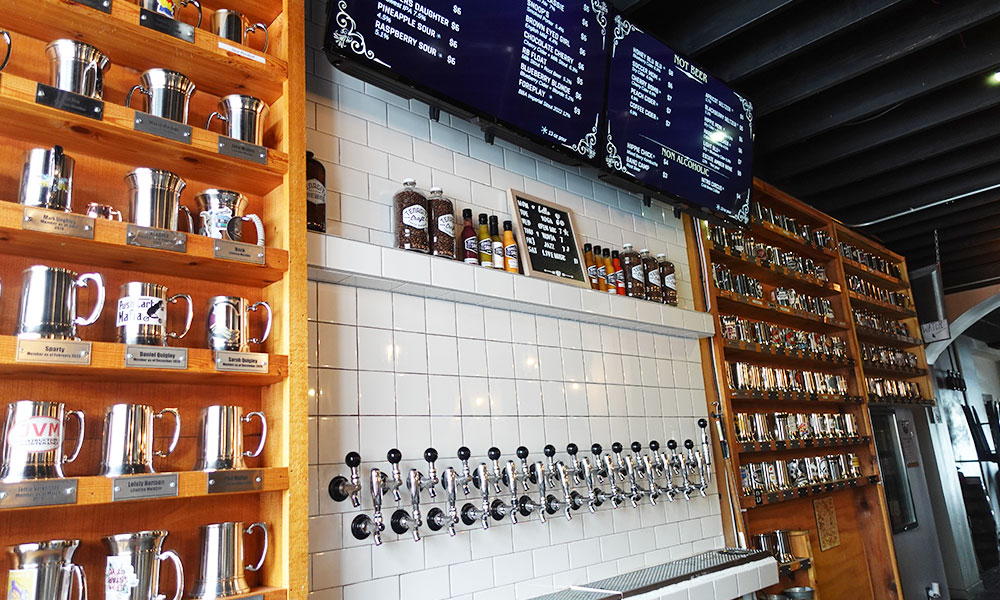 taproom wall with shelves of mug clubs